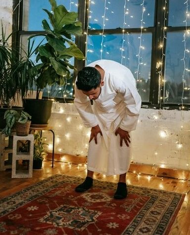  A Muslim bowing down in the Ruku position during Salah.