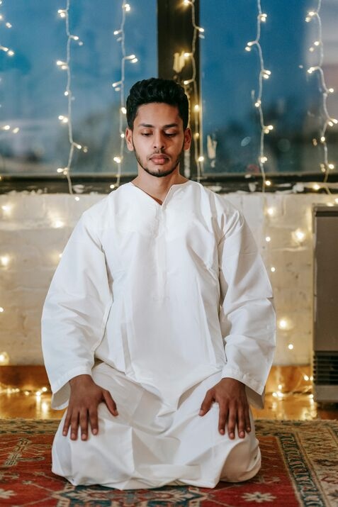 A Muslim sitting straight after performing Sujud, the prostration position in Salah.